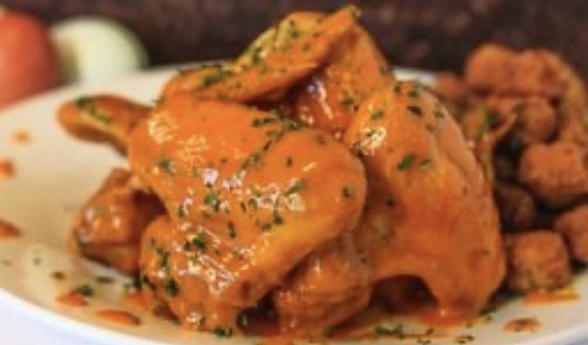Buffalo-sauced wings finished with herbs
