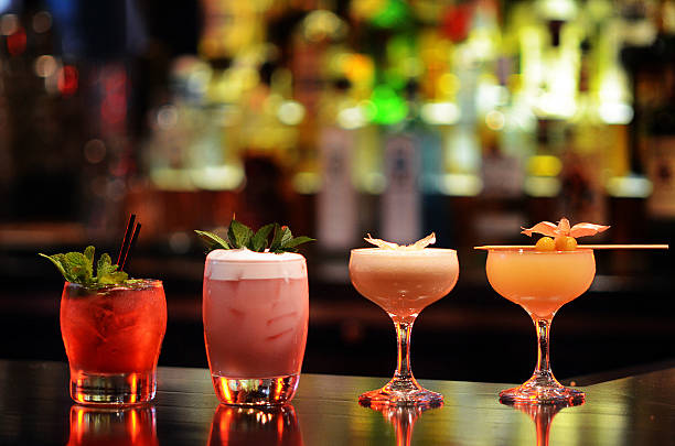 Craft cocktails lined up on the bar at The COOP